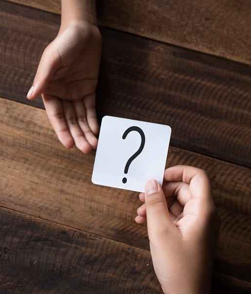 hand giving a note written question mark. asking question concept